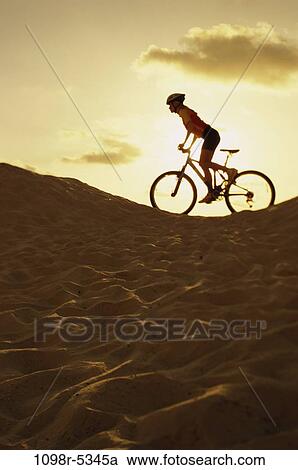 Stock Image - sand, people, woman, dusk, dunes, sunset, beach. Fotosearch