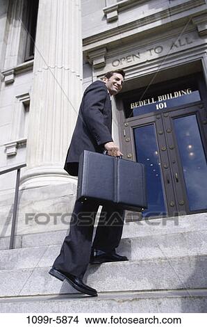 Picture - steps, smiling, building, walking, briefcase, business. Fotosearch