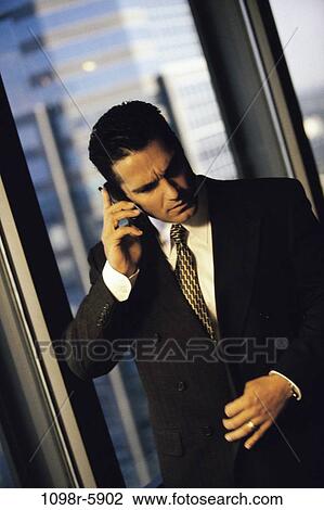 Stock Image - talking, Hispanic, phone, business, Middle-aged, cell phone. Fotosearch