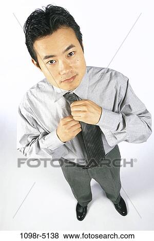 Stock Photo - tie, Asian, business, businessman, indoors, dressed. Fotosearch