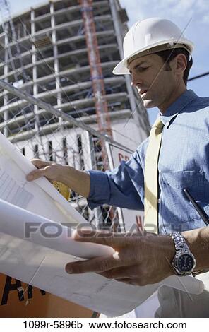 Stock Image - tie, industry, construction, concentrating, worker, outdoors. Fotosearch