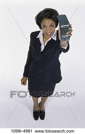 Stock Image - woman, computer, holding, business, hold, indoors, African-American. Fotosearch