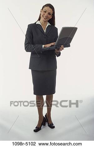 Stock Image - woman, computer, laptop, holding, business, Middle-aged, hold. Fotosearch