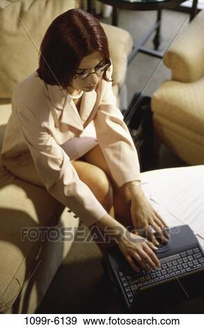 Stock Photo - woman, eyeglasses, computer, laptop, business, indoors. Fotosearch
