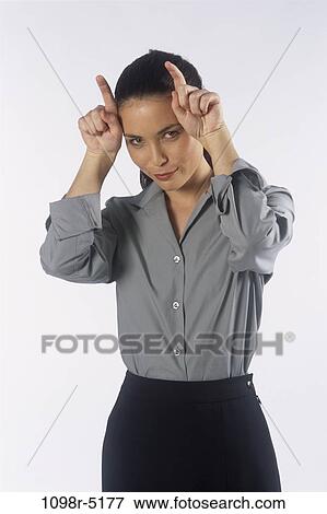 Stock Photo - woman, Hispanic, business, humor, indoors, devilish, businesswoman. Fotosearch