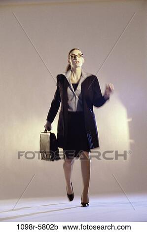 Stock Image - woman, rush, business, indoors, Caucasian, businesswoman, young adult. Fotosearch