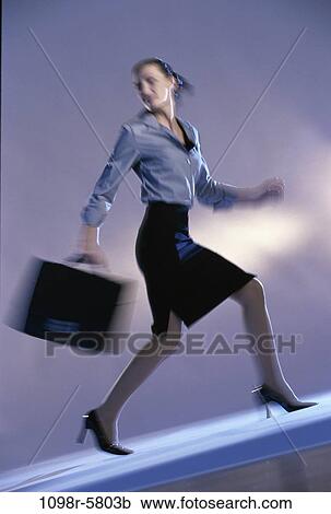 Stock Image - woman, rush, business, indoors, Caucasian, businesswoman, young adult. Fotosearch