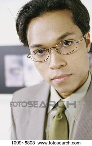 young adult, eyeglasses, indoors, businessman, business, Asian View Large Photo Image Stock Photo - young adult, eyeglasses, indoors, businessman, business, Asian. Fotosearch