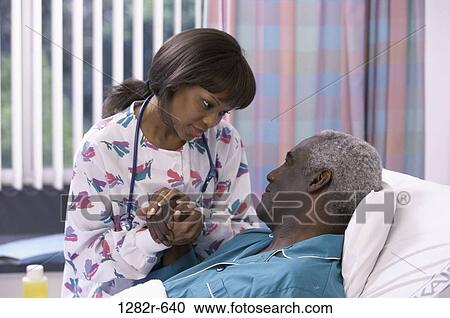 Stock Image - bed, calm, patient, nurse, medicine, nurturing, room. Fotosearch