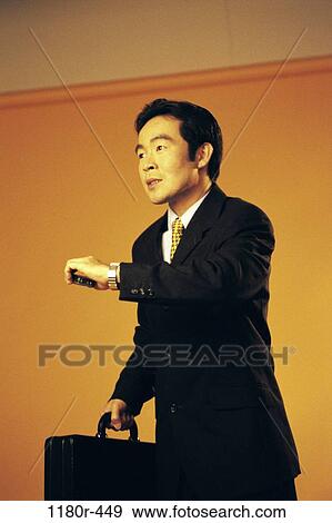 Stock Photo - briefcase, Asian, business, Middle-aged, businessman, indoors. Fotosearch