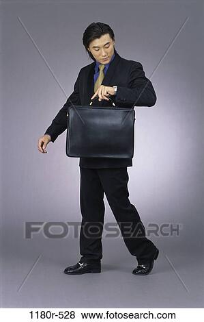 Stock Photo - briefcase, Asian, business, businessman, indoors, anticipating. Fotosearch