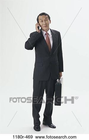 briefcase, talking, Asian, business, Middle-aged, cell phone View Large Photo Image Stock Photo - briefcase, talking, Asian, business, Middle-aged, cell phone. Fotosearch