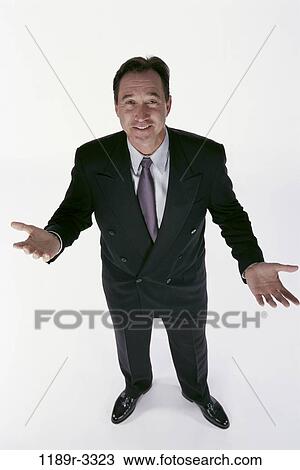 Stock Image - business, Middle-aged, questioning, posing, businessman, indoors. Fotosearch