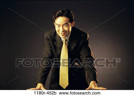 Stock Image - desk, Asian, business, Middle-aged, businessman, indoors. Fotosearch