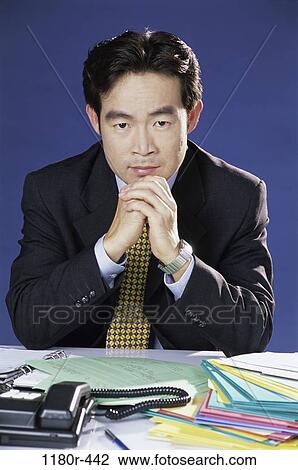 desk, paperwork, Asian, business, serious, businessman View Large Photo Image Stock Image - desk, paperwork, Asian, business, serious, businessman. Fotosearch