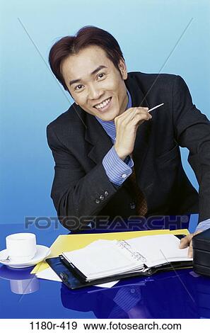Stock Photo - desk, planner, Asian, coffee, appointment book, business. Fotosearch