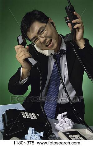 desk, talking, Asian, eyeglasses, stress, business View Large Photo Image Stock Photo - desk, talking, Asian, eyeglasses, stress, business. Fotosearch