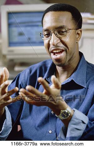 Stock Image - eyeglasses, computer, business, casual, businessman, indoors. Fotosearch