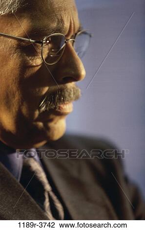 Stock Image - eyeglasses, Hispanic, business, Middle-aged, mustache, serious. Fotosearch