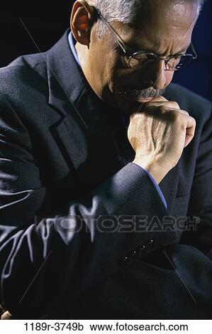 Stock Image - eyeglasses, Hispanic, business, Middle-aged, serious, contemplating. Fotosearch