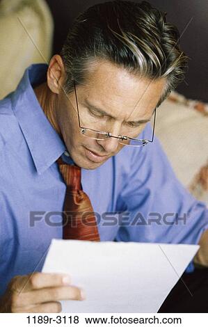 eyeglasses, reading, business, Middle-aged, serious, businessman View Large Photo Image Stock Photo - eyeglasses, reading, business, Middle-aged, serious, businessman. Fotosearch