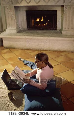 Stock Image - fire, relaxed, people, woman, computer, reading, laptop. Fotosearch