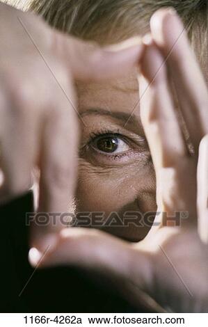 Stock Image - hand, eye, woman, artist, body parts, fingers, frame. Fotosearch
