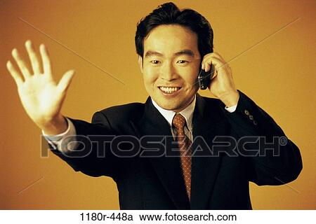 Stock Image - hand, talking, Asian, phone, business, cell phone. Fotosearch