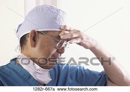 headache, temple, scrubs, doctor, stress, Middle-aged View Large Photo Image Stock Image - headache, temple, scrubs, doctor, stress, Middle-aged. Fotosearch