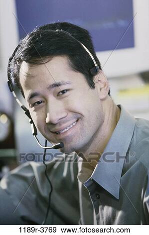 Stock Photo - headset, telephone, Asian, phone, business. Fotosearch