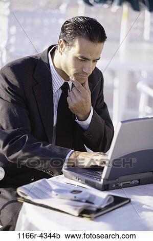 Stock Image - Hispanic, computer, laptop, concentrating, business, outdoors. Fotosearch