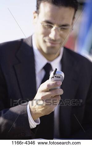 Hispanic, phone, business, outdoors, cell phone, businessman View Large Photo Image Stock Photograph - Hispanic, phone, business, outdoors, cell phone, businessman. Fotosearch