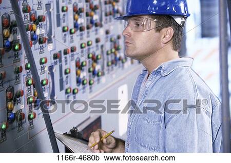 Stock Image - industry, worker, Middle-aged, writing, industrial, serious. Fotosearch