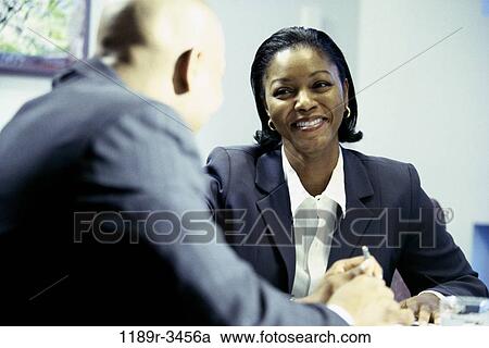 Stock Image - meeting, consultation, talking, discussion, consulting, business, Middle-aged. Fotosearch