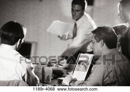 Stock Photo - meeting, people, busy, teamwork, report, black and white. Fotosearch