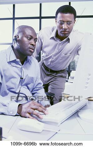 Stock Image - men, desk, telephone, eyeglasses, computer, phone, business. Fotosearch