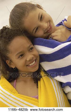 Stock Image - multiethnic, people, beach, friends, children, girls, towels. Fotosearch