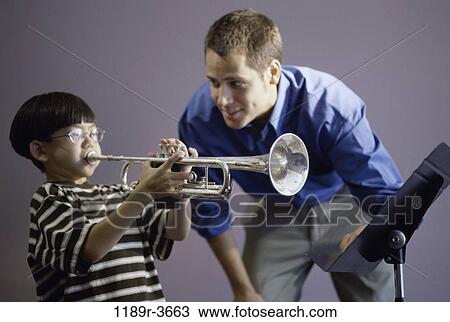 Stock Image - multiethnic, people, teacher, horn, music, student, trumpet. Fotosearch