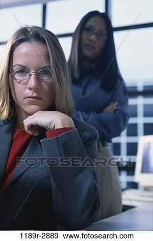 multiethnic, women, desk, eyeglasses, business, serious, casual View Large Photo Image Stock Photo - multiethnic, women, desk, eyeglasses, business, serious, casual. Fotosearch