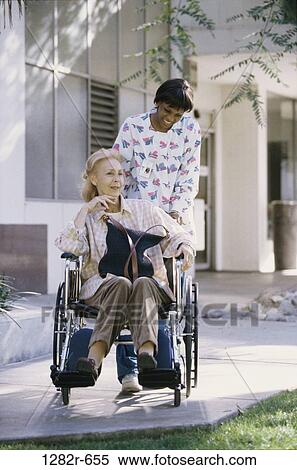 Stock Photography - multiethnic, women, patient, wheelchair, nurse, geriatrics, medicine. Fotosearch