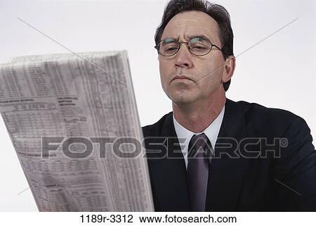 Stock Image - newspaper, reading, business, Middle-aged, businessman, indoors. Fotosearch