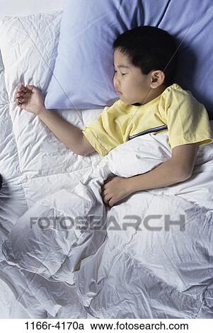 Stock Image - overhead, people, sleeping, Asian, bed, boy, resting. Fotosearch