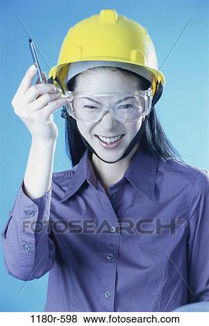 Stock Photo - pen, industry, construction, woman, Asian, worker, safety. Fotosearch