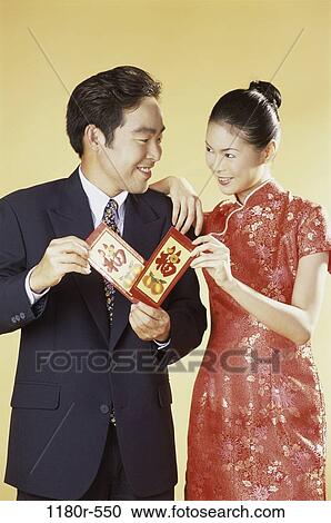 Stock Image - people, Asian, couple, Chinese, holding, new years, exchange. Fotosearch
