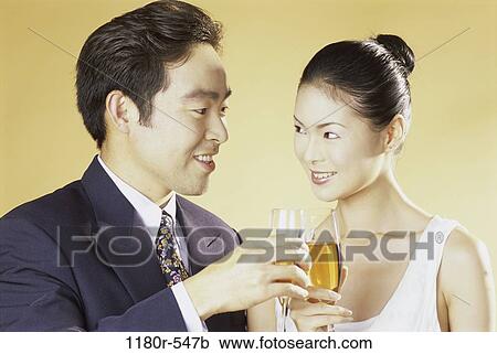 Stock Image - people, Asian, couple, toasting, wine, drinking, toast. Fotosearch