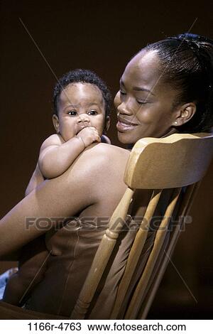 people, chair, mother, baby, family, brunette, careful View Large Photo Image Stock Image - people, chair, mother, baby, family, brunette, careful. Fotosearch