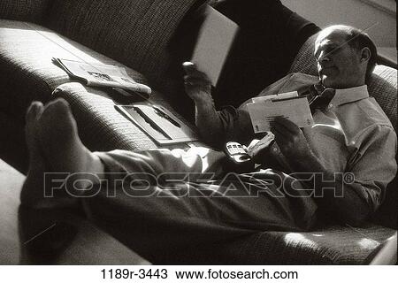 Stock Image - people, couch, business, Middle-aged, businessman, indoors. Fotosearch
