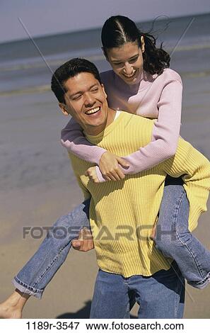 people, couple, beach, carrying, jeans, piggyback, clothed View Large Photo Image Stock Photo - people, couple, beach, carrying, jeans, piggyback, clothed. Fotosearch