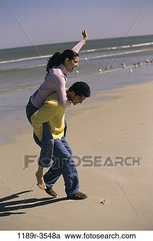 people, couple, beach, playful, carrying, jeans, piggyback View Large Photo Image Stock Image - people, couple, beach, playful, carrying, jeans, piggyback. Fotosearch