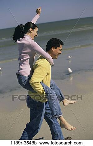 people, couple, beach, playful, carrying, jeans, piggyback View Large Photo Image Stock Image - people, couple, beach, playful, carrying, jeans, piggyback. Fotosearch
